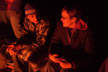 my friends Aaron and Sonja sitting by the fire, faces lit with the firelight